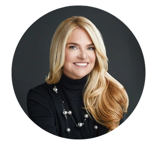 A woman with long blonde hair wearing black.